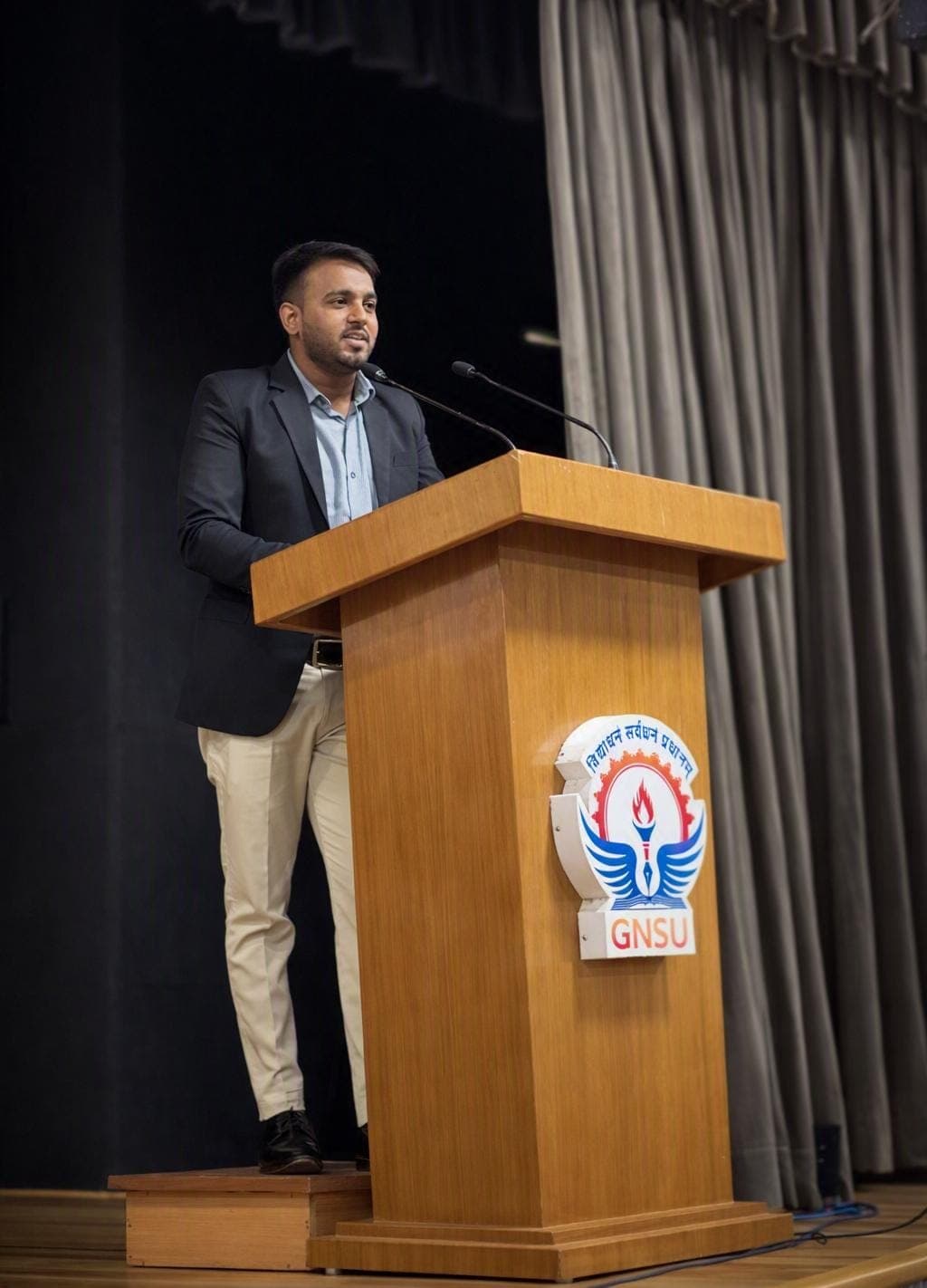 Abhishek Kumar addressing students from a podium